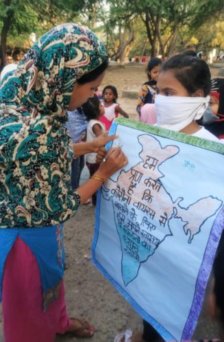 Community members taking pledge to keep themselves and family safe from the deadly coronavirus at Takia Kale Kha, Delhi. Girls took out an awareness drive in the area.