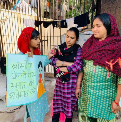 Roshini student of Chintan Nizamuddin learning center spreading awareness among the members of community on importance of using hankie to protect oneself from coronavirus.