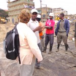 Dandora Waste pickers' Secretary Julius Gitua shares a point with Elaine. Photo credit: Evalyne Wanyama.