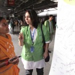 Chintan members explaining the importance of the Earth Day pledge not to litter. Photo credit: Chintan.